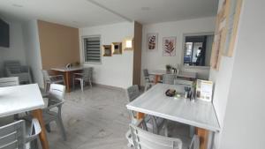 a dining room with chairs and a table and tables at Casa Hotel Solare de la 70 in Medellín +22 photos