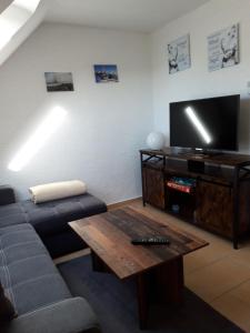a living room with a couch and a coffee table at Haus Morgenstern Fewo Boben in Neuharlingersiel