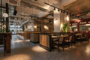 a restaurant with tables and chairs in a room at The Flint Hotel in Belfast