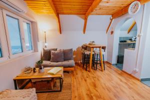 a living room with a couch and a table at Mon Cherry Vendégház in Esztergom