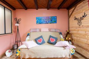 a bedroom with a bed with pillows on it at Aux 4 saisons in Le Bouchet-Mont Charvin