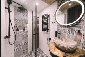 a bathroom with a large stone sink and a mirror at Photographer Rudolf's Studio - ground floor with separate entrance in Rīga +22 photos