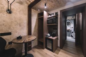 a small room with a table and a bathroom at Photographer Rudolf's Studio - ground floor with separate entrance in Rīga