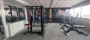 a gym with two rows of equipment in a room at VIP GRAND HOTEL- Nearby Trichy Airport & IIM University in Thondamannallūr