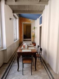 a dining room with a table and chairs in a building at Appartamento Teatro Duse in Bergamo