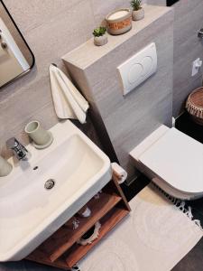 a bathroom with a white sink and a toilet at Harmony Peak Jahorina in Jahorina +76 photos