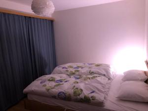 a bedroom with a bed with a comforter on it at Ferienwohnung Kleiner Moor in Bivio