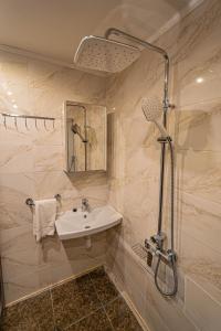 a bathroom with a sink and a shower at The Grand Royal 3BDR Heart of Old Town in Prague