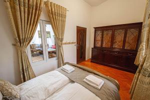a bedroom with a bed and a dresser at The Grand Royal 3BDR Heart of Old Town in Prague
