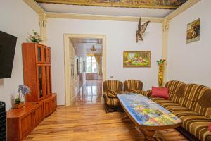 a living room with a couch and a table at The Grand Royal 3BDR Heart of Old Town in Prague