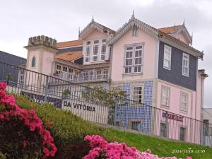 a large white house on a hill with pink flowers at Palacio Nova Seara 2503 - AL in Armamar