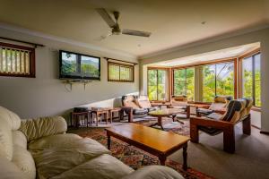 a living room with a couch and a table at Bella Vista Bellingen in Bellingen