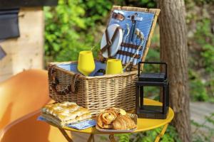 a picnic basket with bread and pastries on a table at Starsbox Cinque Terre in Carrodano Inferiore
