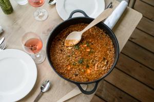 a pan of food on a table with a spoon at ARTIEM Audax - Adults Only in Cala Galdana