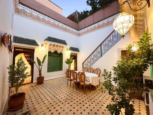a dining room with a table and chairs at Riad M Azbetz in Marrakech
