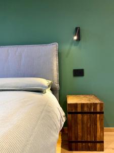 a bedroom with a bed and a night stand next to it at La Primula in Pragelato +13 photos