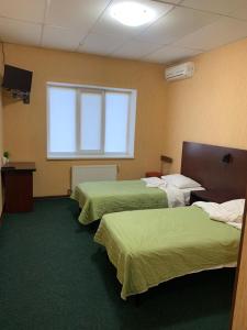Postel nebo postele na pokoji v ubytování Центр автотуризму М12