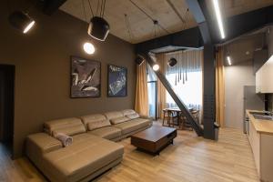a living room with a couch and a table at ArtHomes Apartments in Timişoara