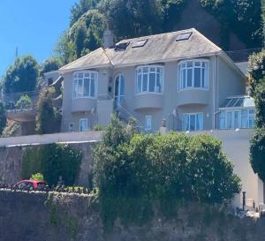 a house on the side of a mountain at MarinaSeaView-4Br-8Guests-FreeParking-PetsFriendly in Torquay +14 photos