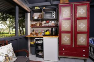 a kitchen with a counter and a red cabinet at Soetlemoen in George