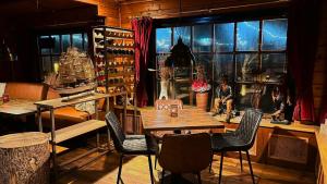 a dining room with a table and chairs and a window at Golfvilla 38 in Hollum