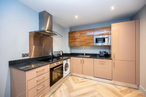 a kitchen with a sink and a stove at Staycity Aparthotels Edinburgh West End in Edinburgh