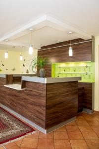 a lobby of a hotel with a counter with wood at Gasthof-Pension Ölberger in Wolfsberg