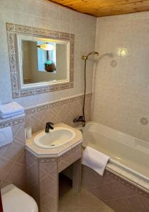 a bathroom with a sink and a bath tub at Villa Menhardi in Nová Lesná +18 photos