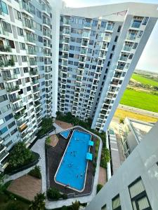 an aerial view of a swimming pool in front of tall buildings at T- Plus Apartment - Căn hộ 2 PN view hồ bơi in Thôn Văn Dương