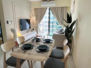 a dining table and chairs in a living room at Muji Haus near Sunway City #2Bedroom #Netflix in Subang Jaya
