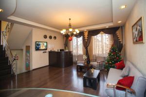 a living room with a christmas tree in it at Hotel 4You in Tbilisi City