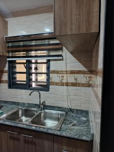 a kitchen with a sink and a window at Rama Garden Service Apartment Akure in Akure