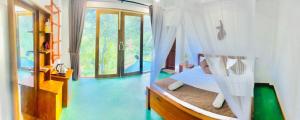 a bedroom with a bed with a hammock in it at Serenity cottage in Ella