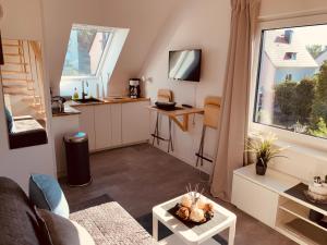 a small living room with a table and a window at Moderne Ferienwohnung in Berlin Lichtenrade in Berlin