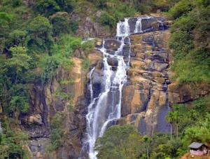 a waterfall on the side of a mountain at Serenity cottage in Ella
