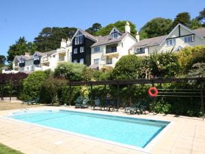 a swimming pool in front of a house at 17 St Elmo Court in Salcombe