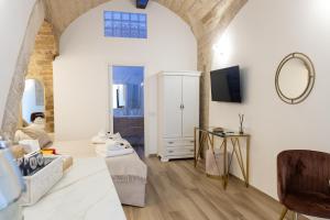 a living room with a table and a mirror at Carola Luxury Room in Bari