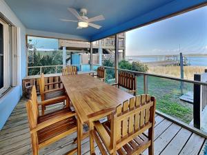a dining room with a wooden table and chairs at Whitaker Sea La Vie in Surf City