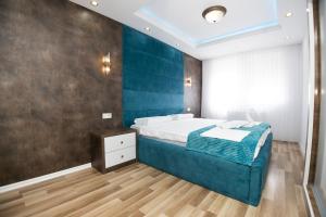 Postel nebo postele na pokoji v ubytování Dodona ApartHotel in Prishtina