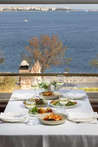 a table with plates of food and glasses of wine at Armada Istanbul Old City Hotel in Istanbul