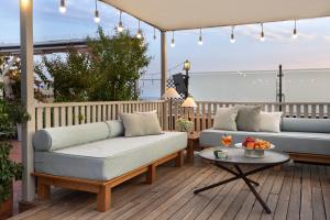 a patio with two couches and a table on a deck at Armada Istanbul Old City Hotel in Istanbul