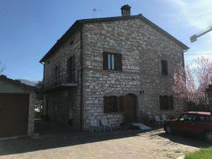 an old stone building with chairs in front of it at Casa delle Sirene in Perugia