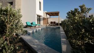 a swimming pool in the middle of a house at Summer Sense, New Private Retreat with Private Pool, Agia Anna, Naxos in Agia Anna +28 photos