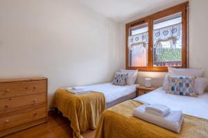 a bedroom with two beds and a dresser and a window at Delice - City center Les Houches & Free Parking - By Cozee Rentals in Les Houches