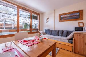 a living room with a couch and a table at Delice - City center Les Houches & Free Parking - By Cozee Rentals in Les Houches