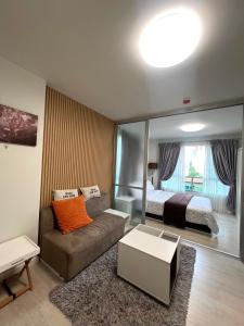 a living room with a couch and a bed at D condo sign D4 in Chiang Mai