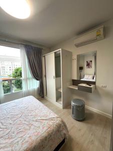 a bedroom with a bed and a large window at D condo sign D4 in Chiang Mai +7 photos