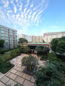 a view of a courtyard with trees and buildings at D condo sign D4 in Chiang Mai