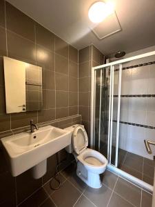 a bathroom with a toilet and a sink and a shower at D condo sign D4 in Chiang Mai