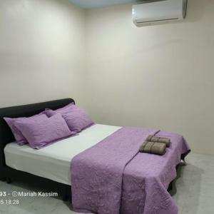 a rendering of a bed with purple blankets and pillows at MKF Homestay Padang Stang, Gerik in Gerik
